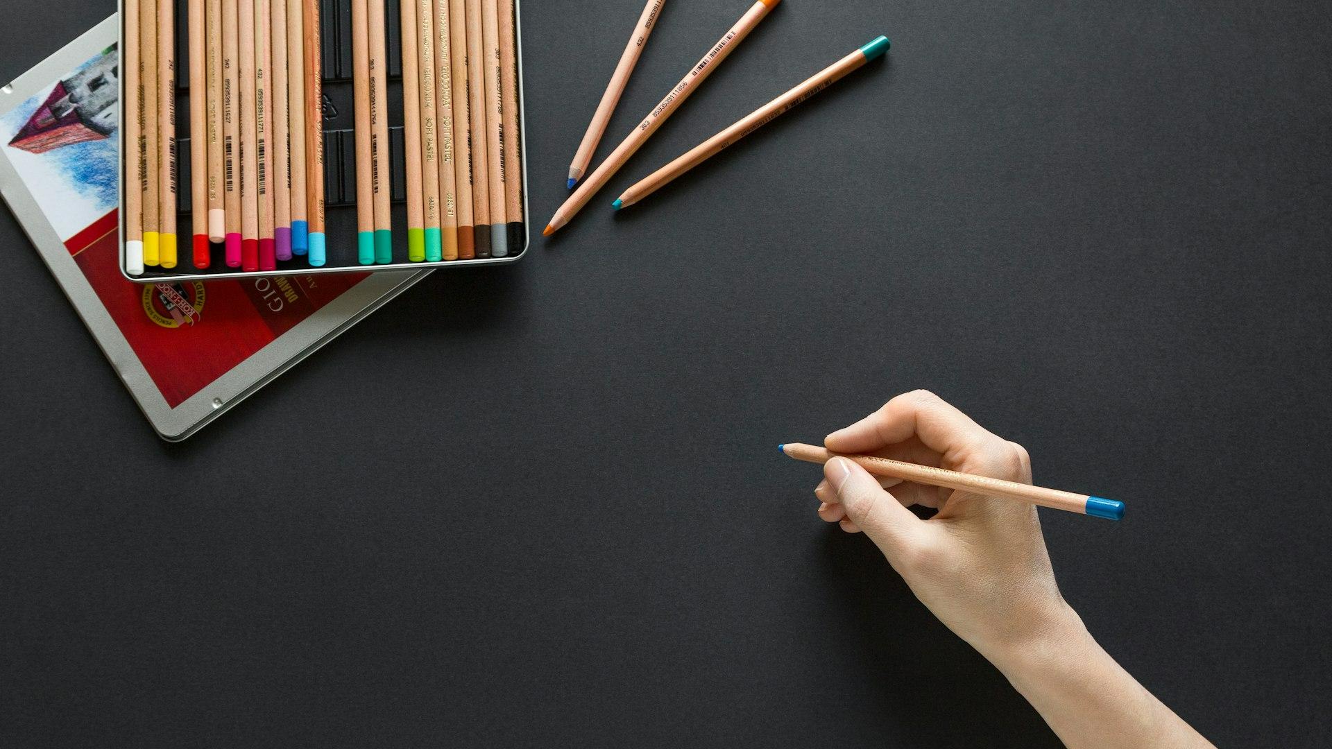person holding brown pencil
